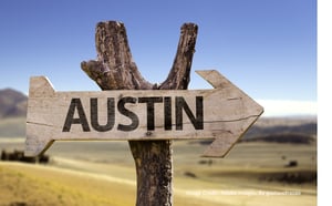 Hot day in Austin with a wooden sign that reads "Austin".