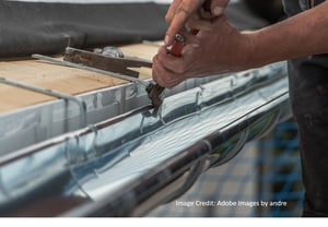 A man repairing a metal roof