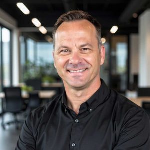 rofessional portrait of Longhorn Roofing project manager Brady Traywick in a modern Austin office.